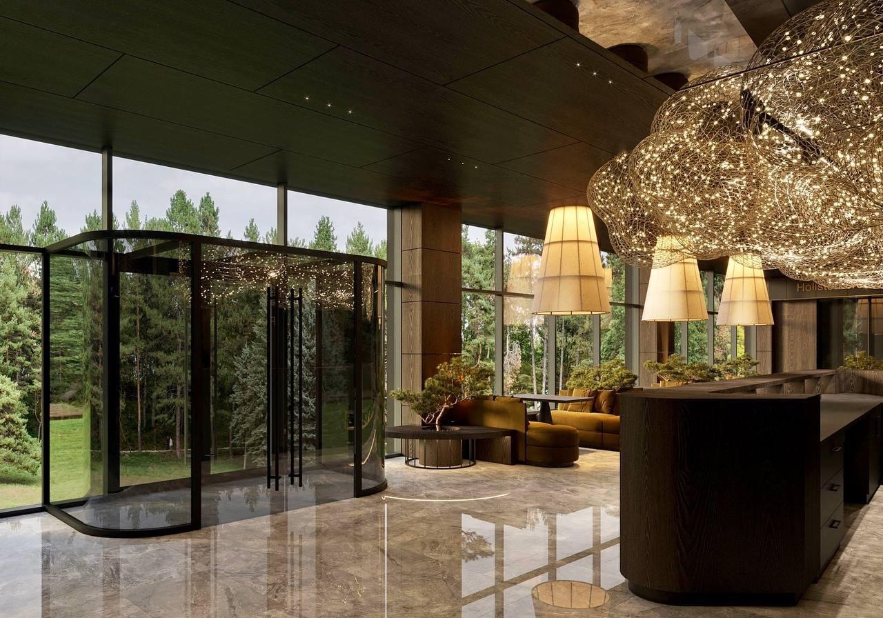 Arrival hall with a glass revolving door opening to the forest